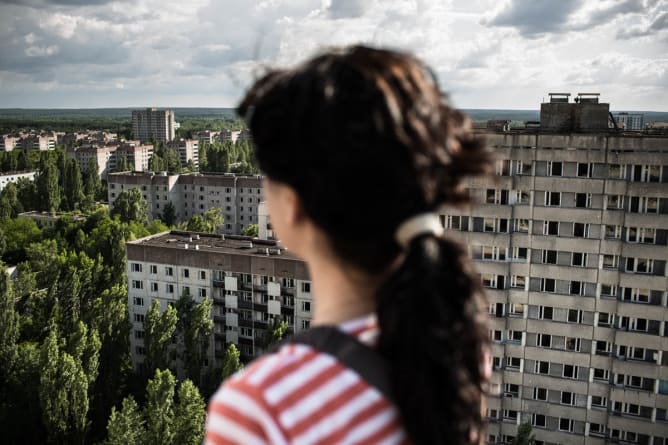 Sasha looks at Pripyat from the roof of its tallest building