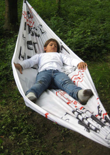 Hammock Every hammock was made out of various herbst-flags, on the spot in Graz from 2006 – 2009. Includes bag for transport, handmade, numbered, limited edition: 40 pieces   Designed by glückslabor