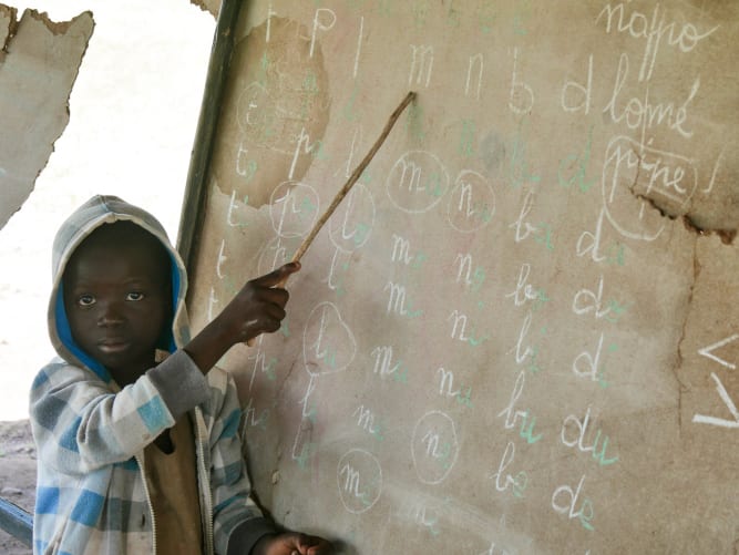 A student with a damaged blackboard