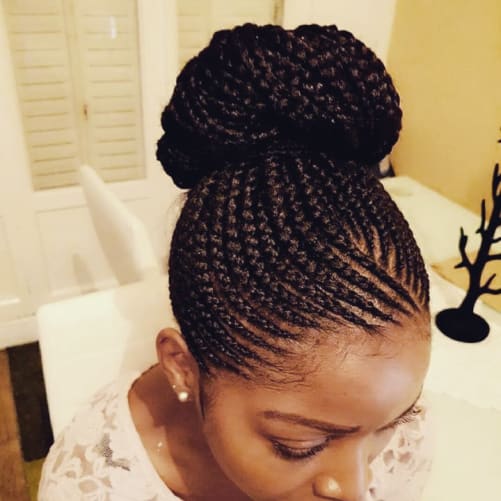 Medium size cornrows in a bun made by one of AfroCoiffeur Stylists