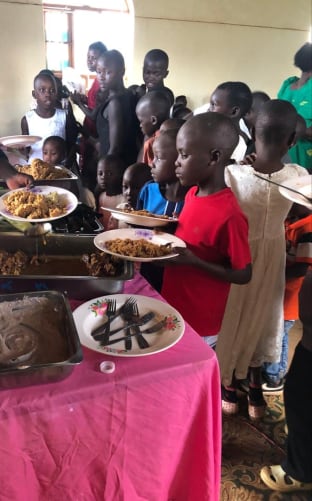 The children eat at church after Sunday mass.