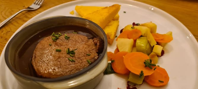 Braised beef with polenta slice and market vegetables