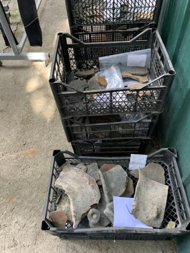 Numerous archaeological finds such as pottery and iron tools need to be cleaned, documented, and deposited in a museum.