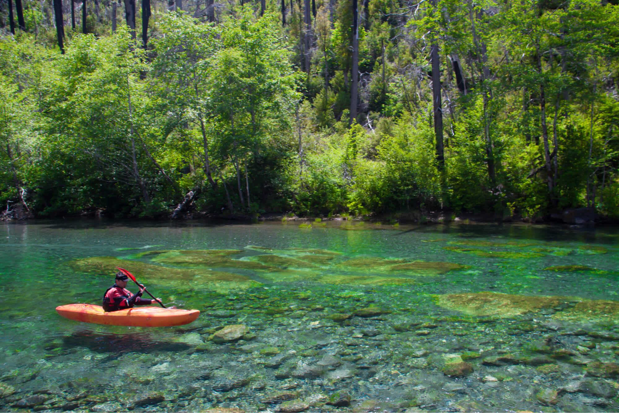 A person kayaking on Chetco river