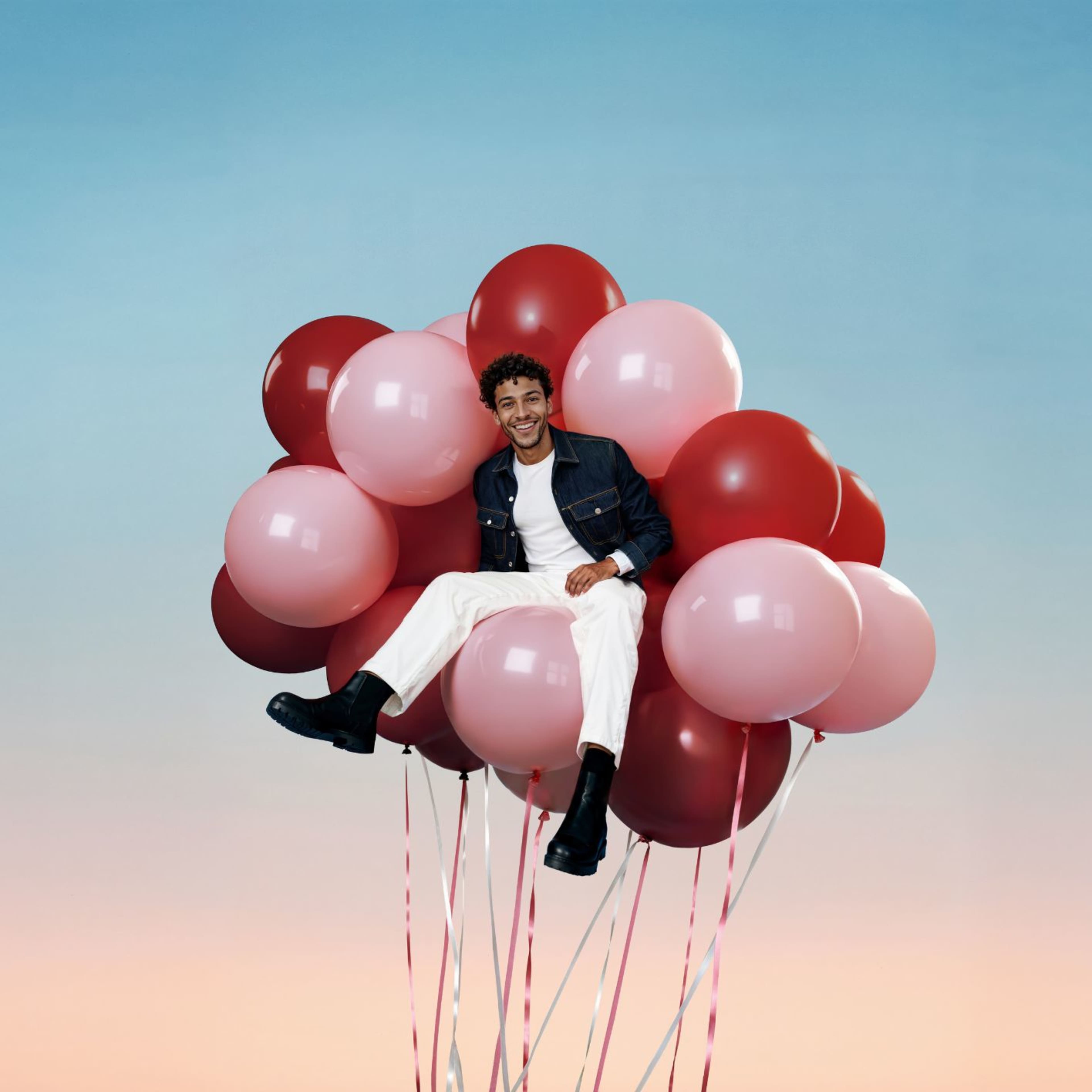 Man sitting on balloons