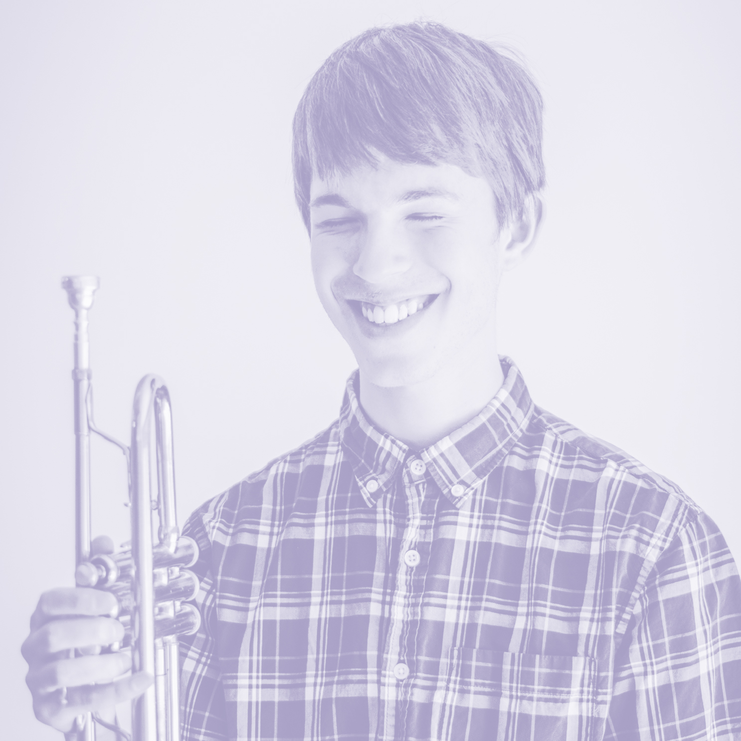 Honors student smiling with trumpet