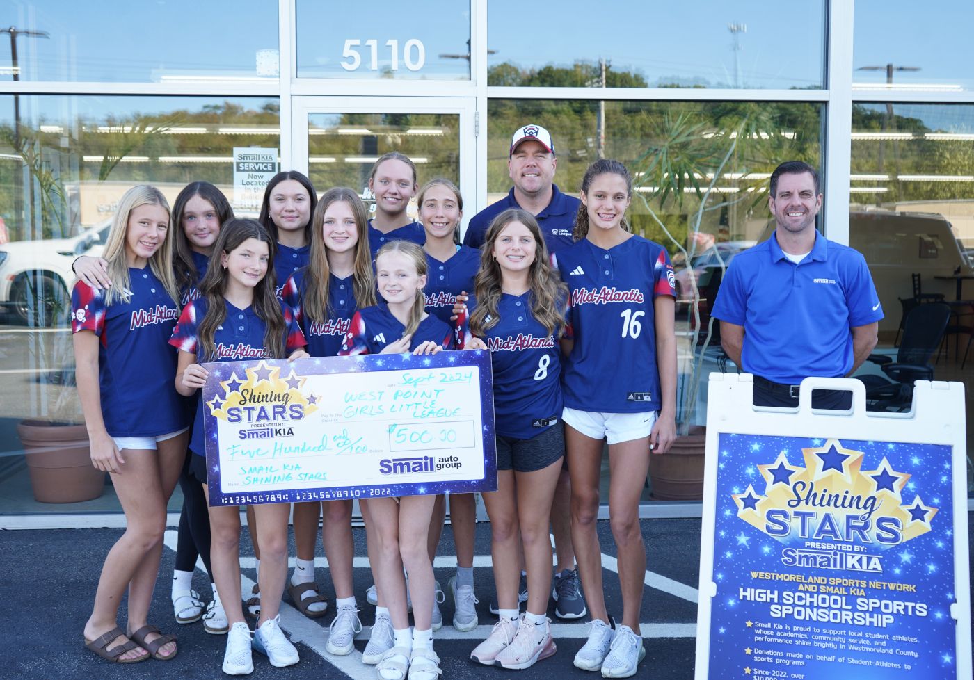 Pictured front row from L-R: Alana Graft, Braylyn Graft, Mia Graft, Piper Hoppell, Lilly Carol, Jayelyn Luft, Jeff Mikell (Smail Kia). Back row: Jocelyn Luft, Rian Starz, Peyton Reamer, Lexi Stabile, Coach Bob Madison.