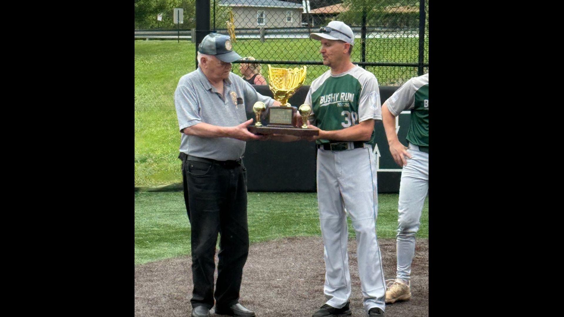 Bushy Run coach Scott Peyman receives the District 31 Championship trophy.
