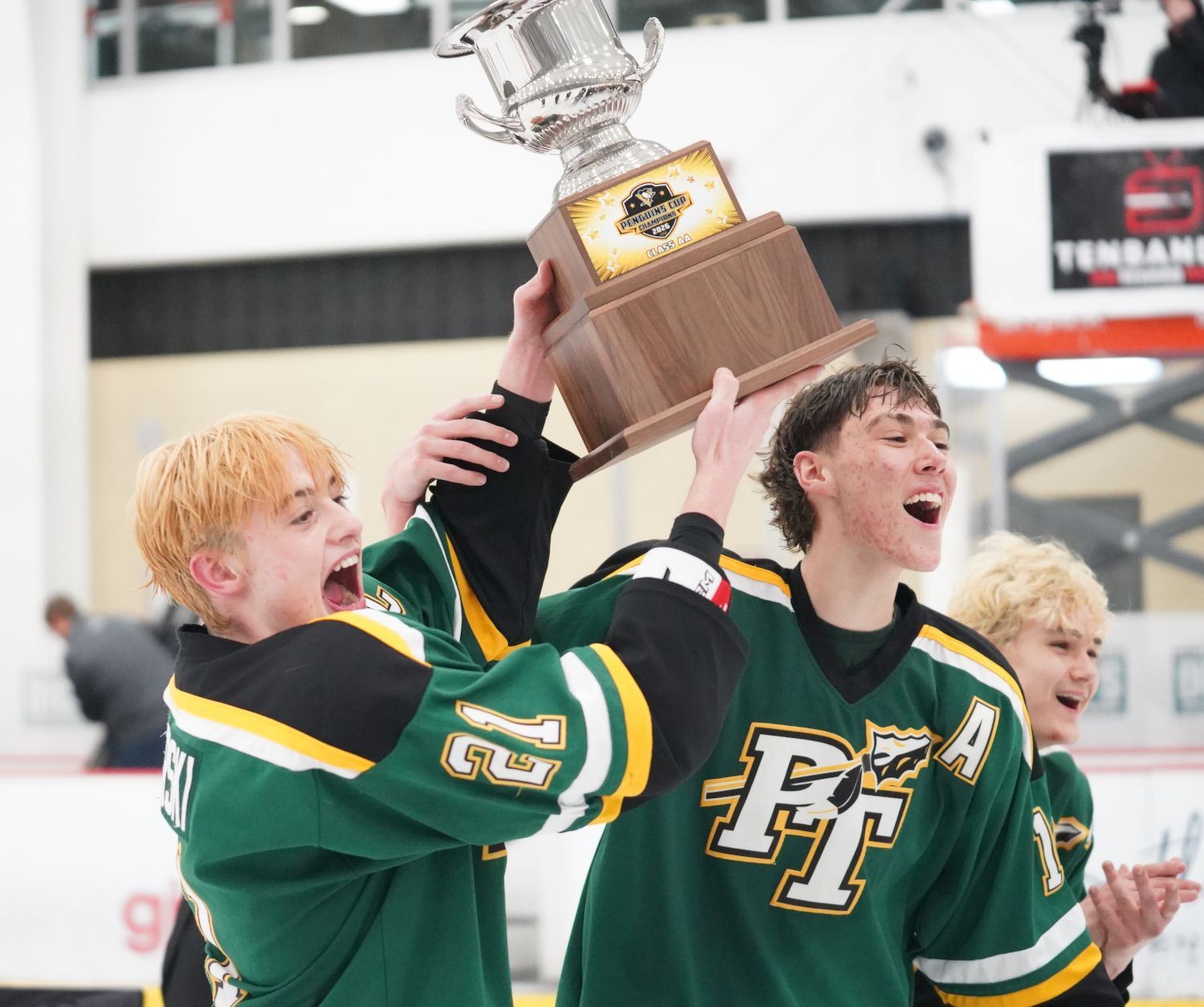 Penn-Trafford captain Ben Zierski and alternate captain Jake Lenart celebrate with the Penguins Cup after beating Hempfield Area 4-3 at the UPMC Lemieux Complex.
