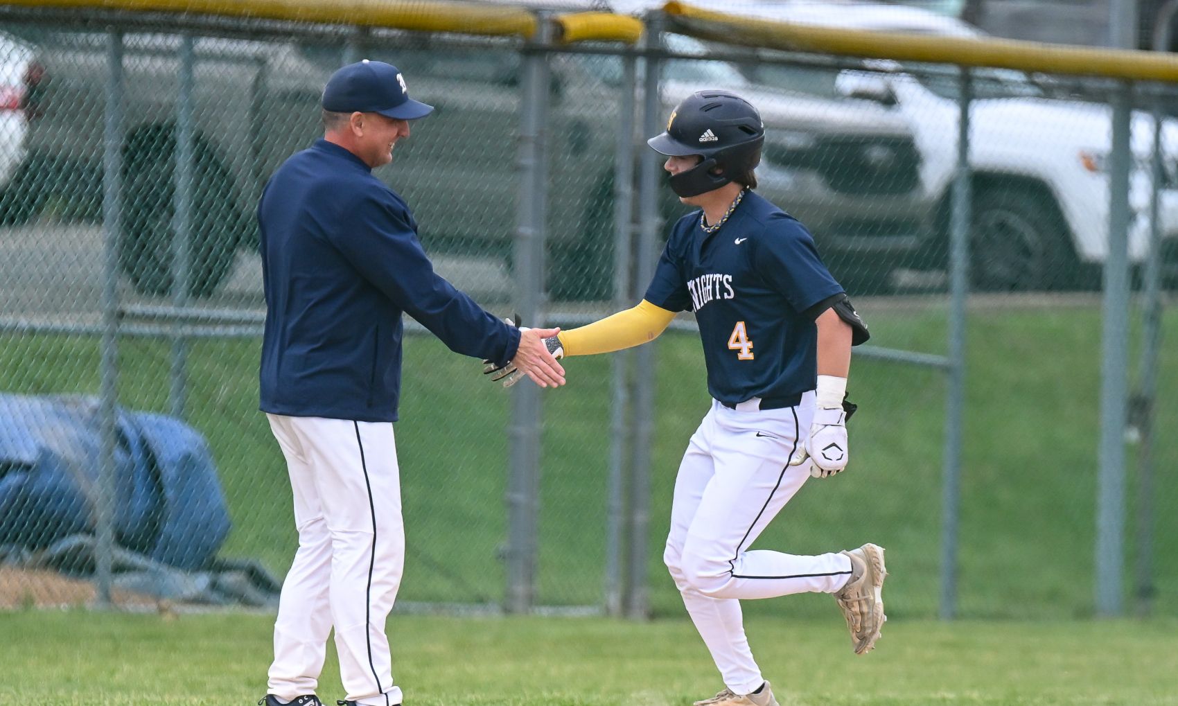 Norwin's Zane Markovitz celebrates with coach Craig Spisak after hitting a two-run homer in the second inning of the Knights 6-5 win over Hempfield Area. (Photo by www.westernpasports.com)