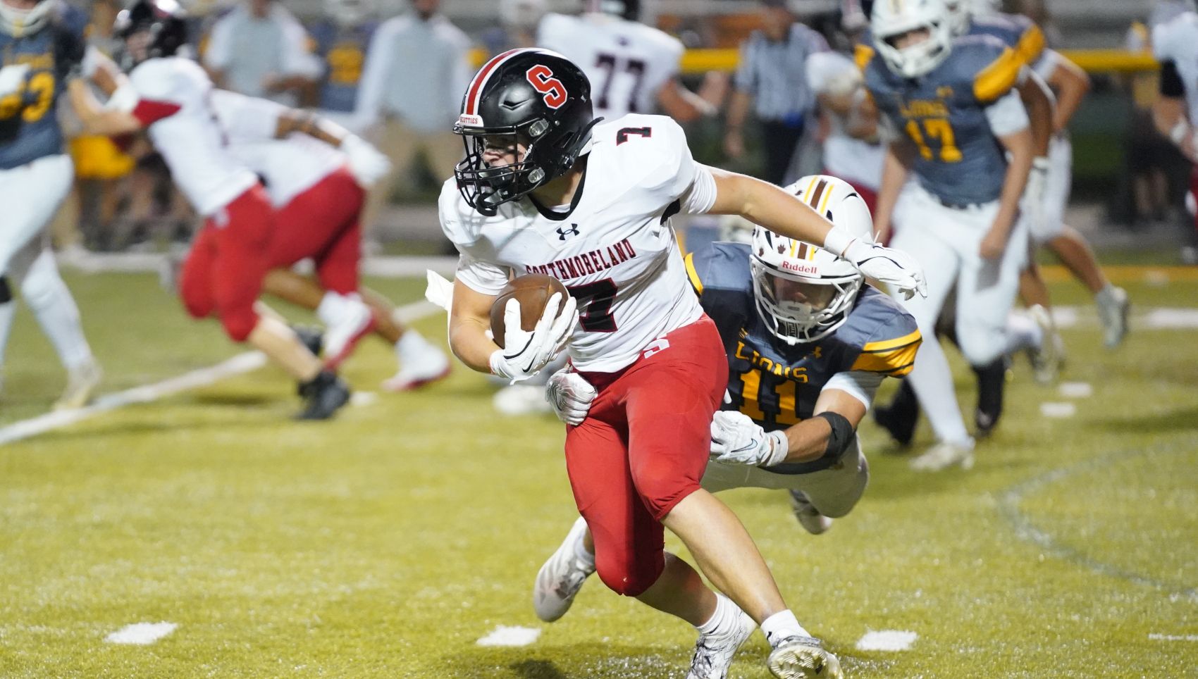Southmoreland's Brock Geho attempts to break the tackle of Greensburg Salem's Braydon Miller Friday night at Offutt Field. (Photo by Sean Delaney)