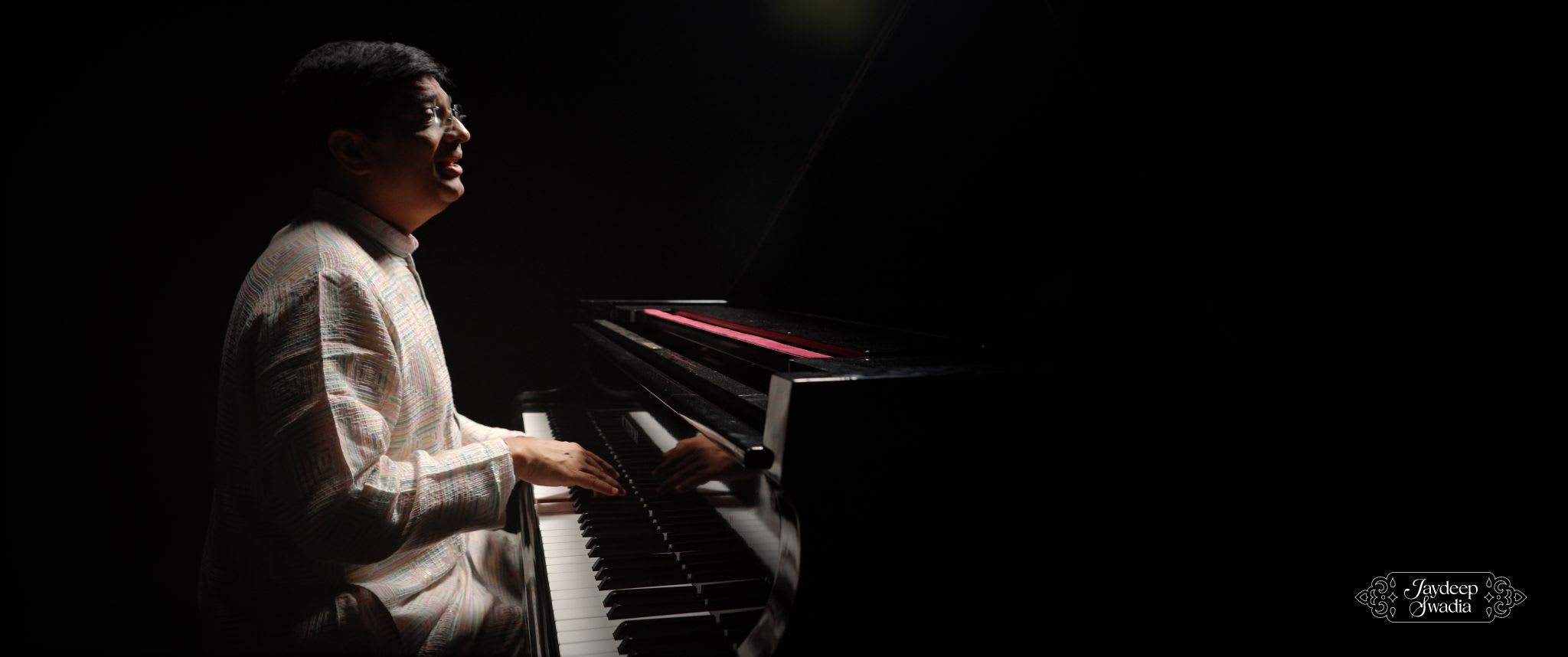 Jaydeep Swadia performing in a cinematic, high-contrast music visual.