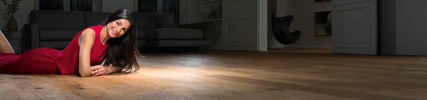 Woman lying on a wooden floor