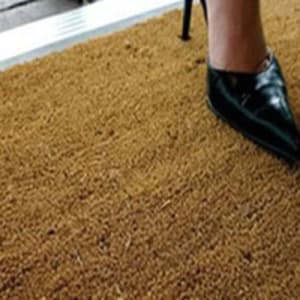 Woman standing on Coir Matting door mat