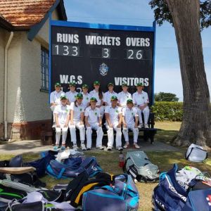 The team all smiles in front of the Whanganui Collegiate scoreboard at the conclusion of the final.