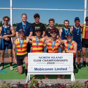 The AWRC senior men coxless quad winners Jonty Thomson, (left), Guy Thomson (both ex WHS students), Tom Monaghan and Luke Watts kneel centre stage on the North Island Club Champ podium at Lake Karapiro.  Photo / Light and Motion Photography.