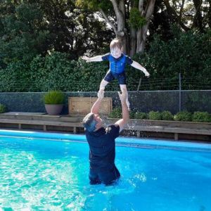 Jethro is passionate about swimming and loves spending time with his dad Phil. Photo / Supplied