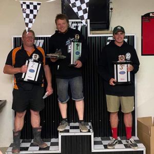 Whanganui drivers Dion Mooney, left, and Callum Sturzaker, right, flank NZ Stockcar Grand Prix winner Harley Robb.   Photo / Supplied.