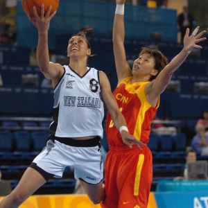 Megan Compain attempts a lay up under pressure from China at the 2004 Olympics. Photo: Getty Images.