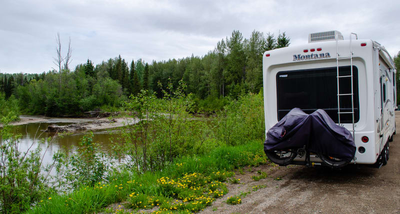 our rv parked along a river in a highway rest area