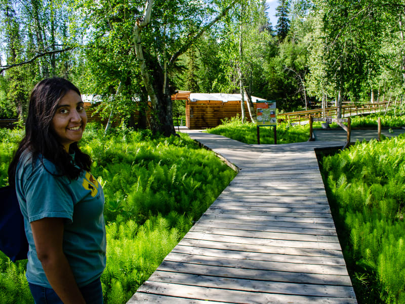 sushila smiling on the boardwalk just before arriving at the springs