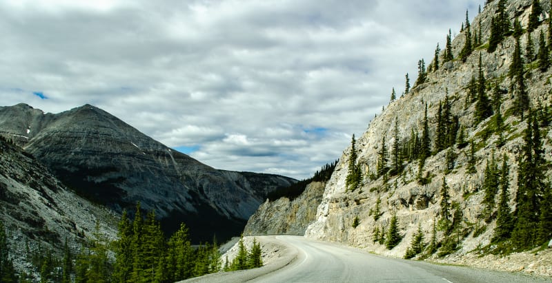 descending into a wide canyon from the high point along the alaska highway