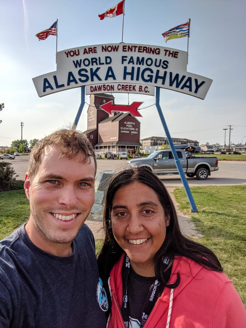 will and sushila taking a selfie in front of the mile 0 sign