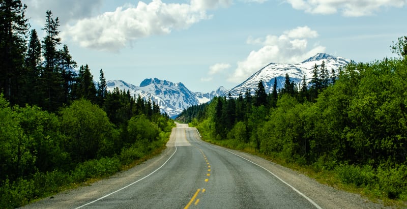 driving towards snowcapped mountains