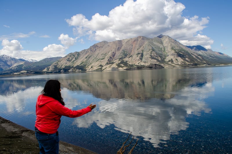 sushila skipping a stone on the lake