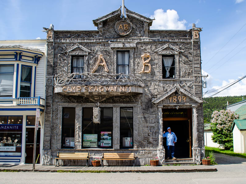 a building with intricate patterns made with driftwood covering the front