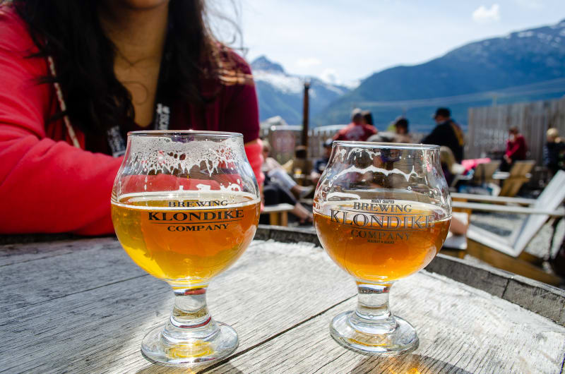 two beer glasses labeled klondike brewing