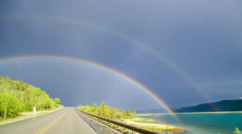 a double rainbow over the road