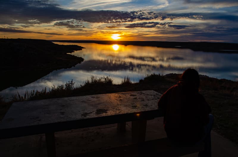 sushila watching the sun set at lake meredith nra