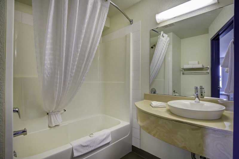 Fresh, clean bathroom with a convenient tub and shower combination for comfort and ease.