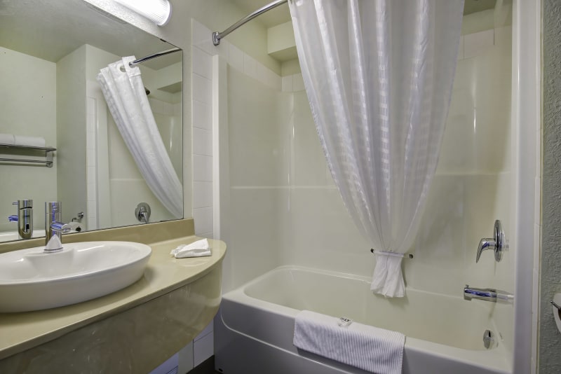Fresh, clean bathroom with a convenient tub and shower combination for comfort and ease.