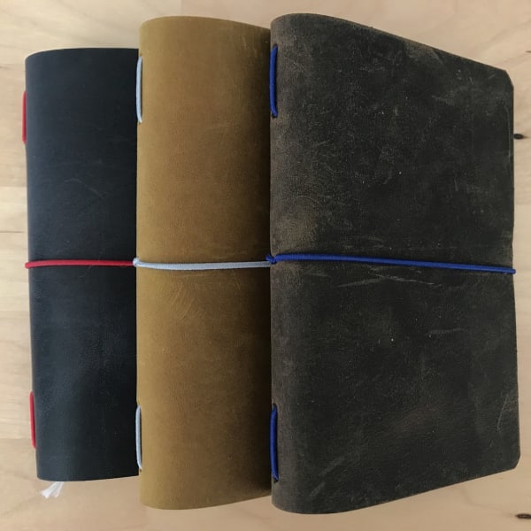 Passport size Traveler's notebook leather cover. Traveler's notebook notebook cover in passport size, cover holds 2 notebooks
comes with a pocket folder insert
comes with 1 passport sized notebook (B7 size notebook dimensions 5" x 3.5")