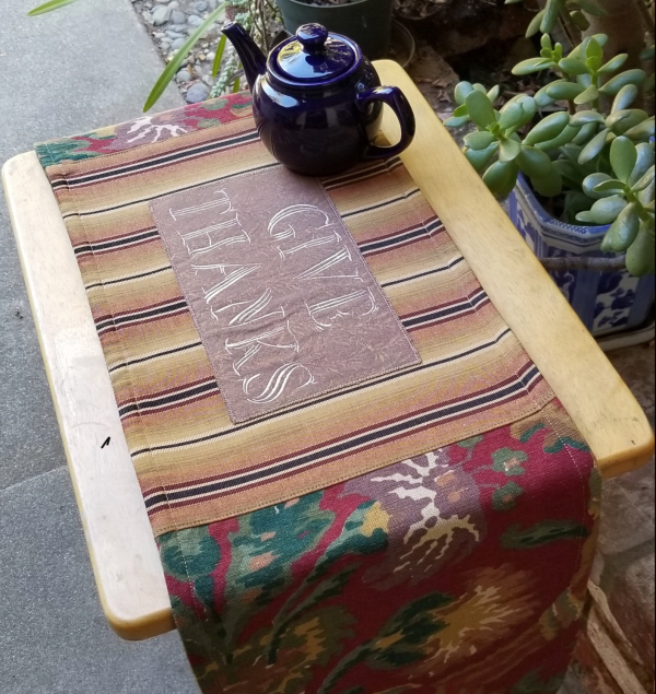 Show your gratitude on your table (or dresser, cabinet, piano, bookcase, etc.) with this lovely embroidered “Give Thanks” runner, whether it’s on Thanksgiving, or all year long.
These rich, earth tone  colored FabMo home decor fabrics were rescued from the landfill, and given new life. Click on my Etsy shop link for more details on this locally made piece.
FREE shipping, or arrange to pickup in Cupertino! 