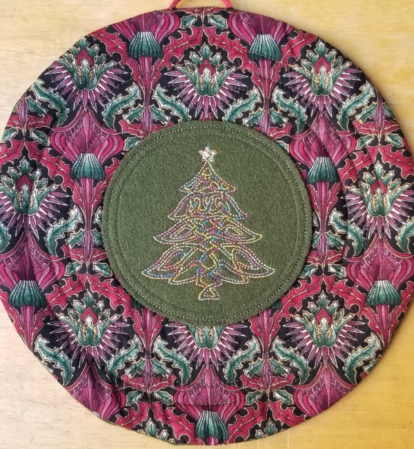 This lovely "Celtic knot" Christmas tree is a hanging trivet that does double duty during the holidays! You can hang it on you wall or door, or use it as a trivet on your table as it's padded with insulbright poly mylar. The embroidery is done with a variegated rayon thread for an extra pop of color! Please click on the link to my Etsy shop for further product details. FREE SHIPPING anywhere in the US, or arrange for pickup in Cupertino.