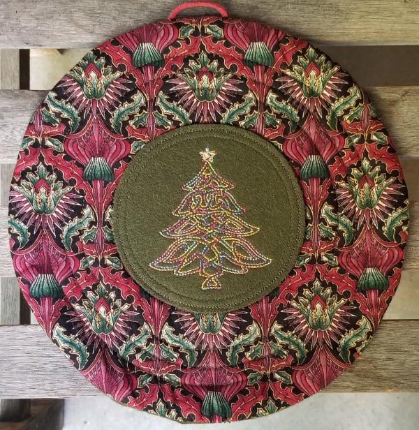 This lovely "Celtic knot" Christmas tree is a hanging trivet that does double duty during the holidays! You can hang it on you wall or door, or use it as a trivet on your table as it's padded with insulbright poly mylar. The embroidery is done with a variegated rayon thread for an extra pop of color! Please click on the link to my Etsy shop for further product details. FREE SHIPPING anywhere in the US, or arrange for pickup in Cupertino.