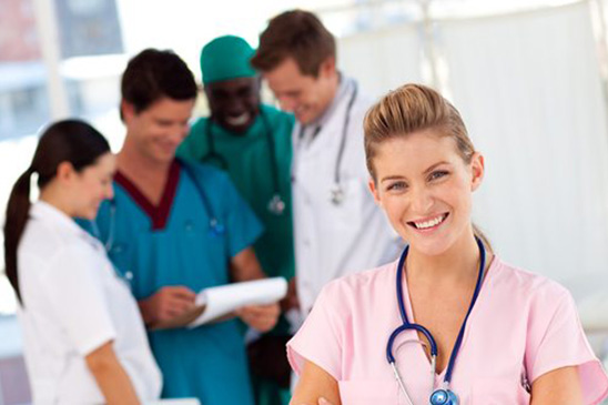industries_0001_nurse-with-doctors-in-the-background Specialty Healthcare