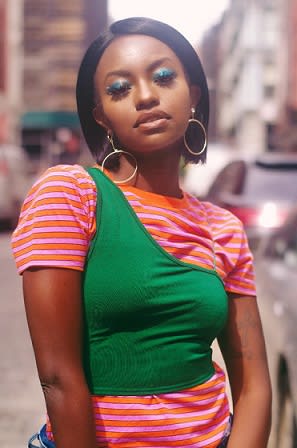 Young Lady Wearing Orange and Green Shirt