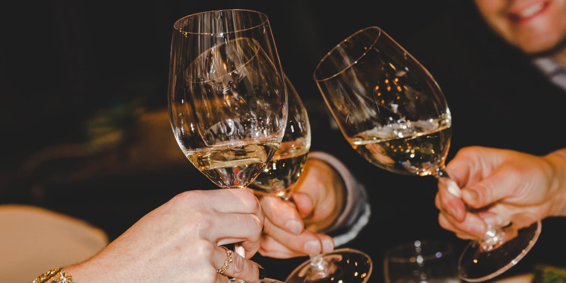 Three people toasting with wine glasses at a Whistler Cornucopia event