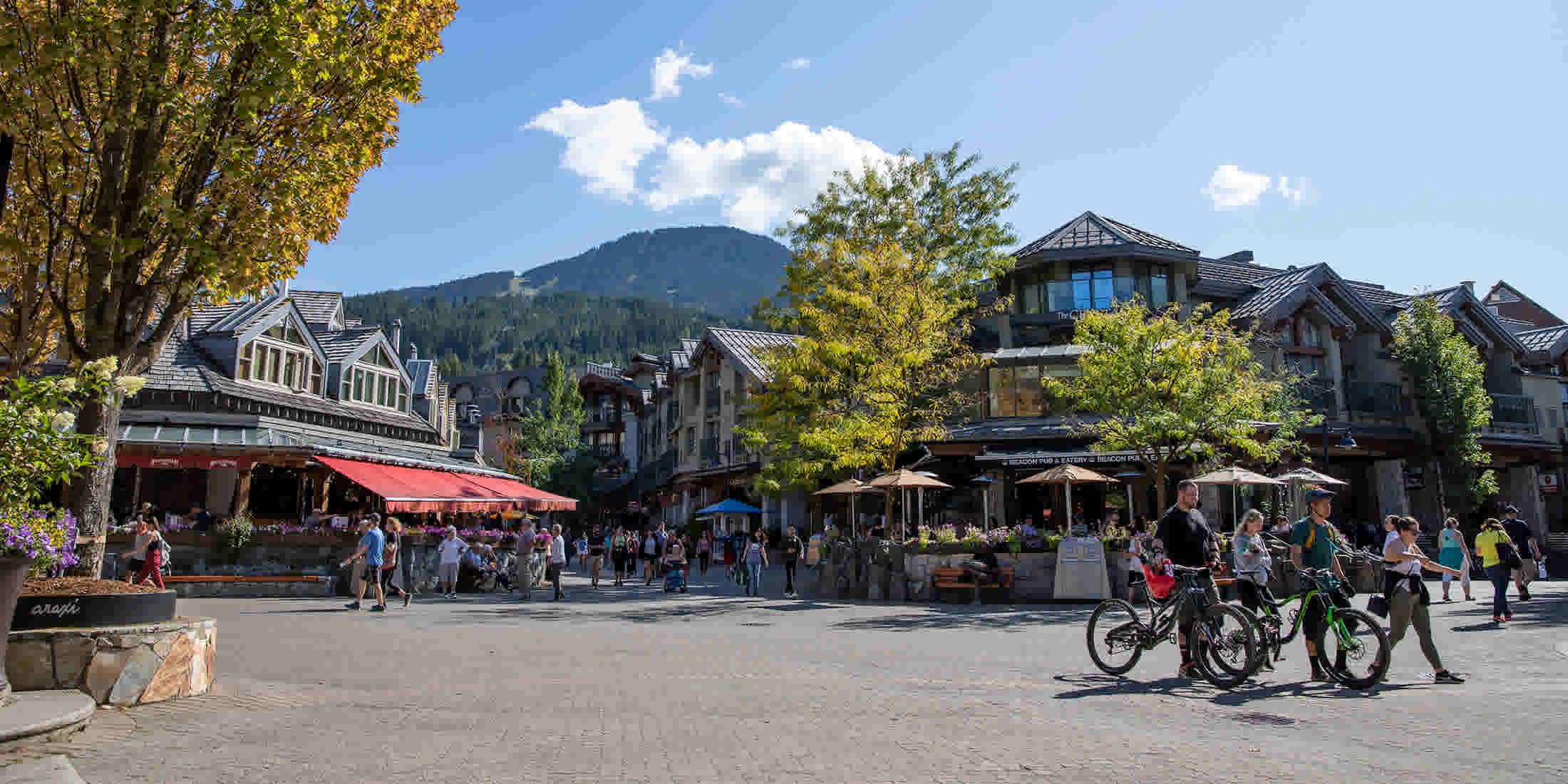 Riders walking to their bike-friendly accommodation in Whistler Village