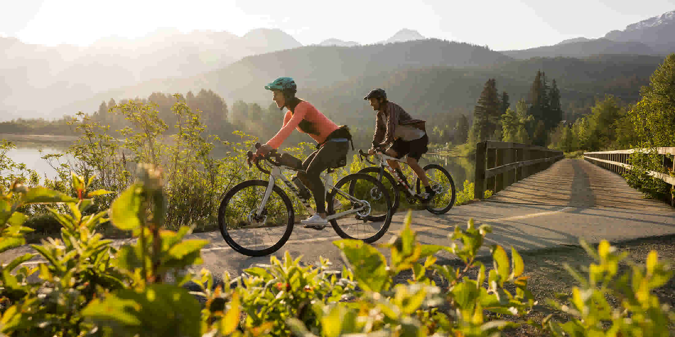 A couple riding bikes on the Valley Trail at Green Lake in Whistler