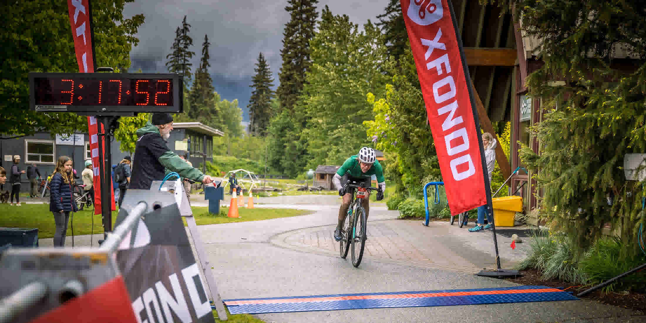 Three riders going down a cross-country trail in the forest at XFONDO Whistler