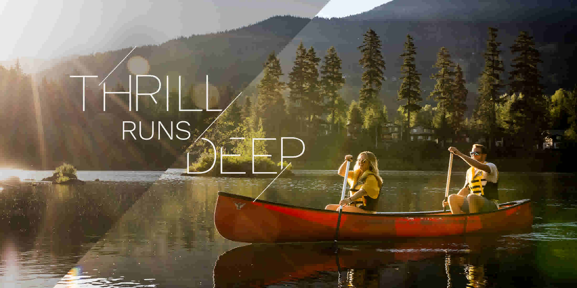 Two people canoeing on Nita Lake on a sunny summer day in Whistler