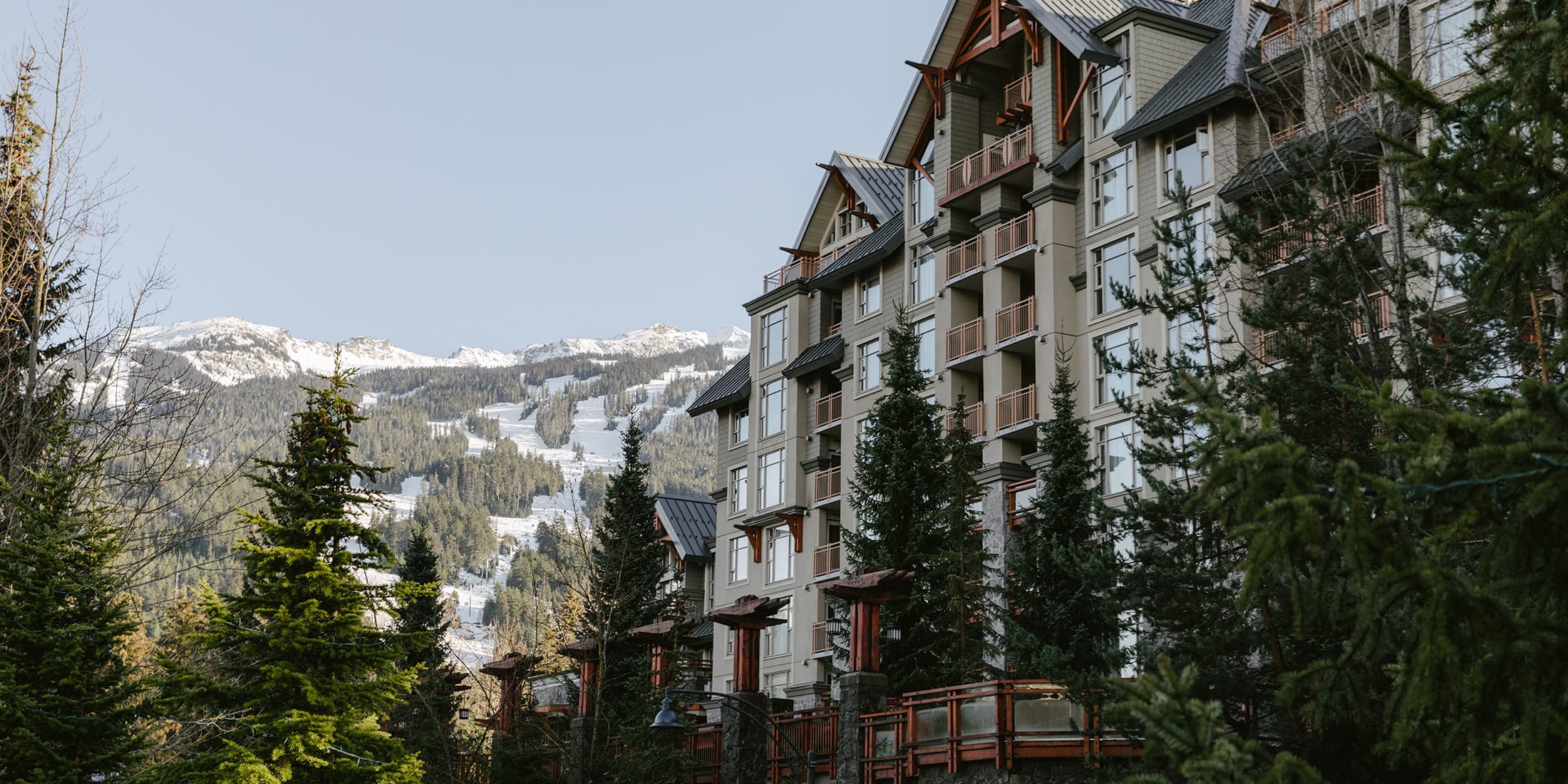 Hotel in Whistler with snow covered mountain in the background