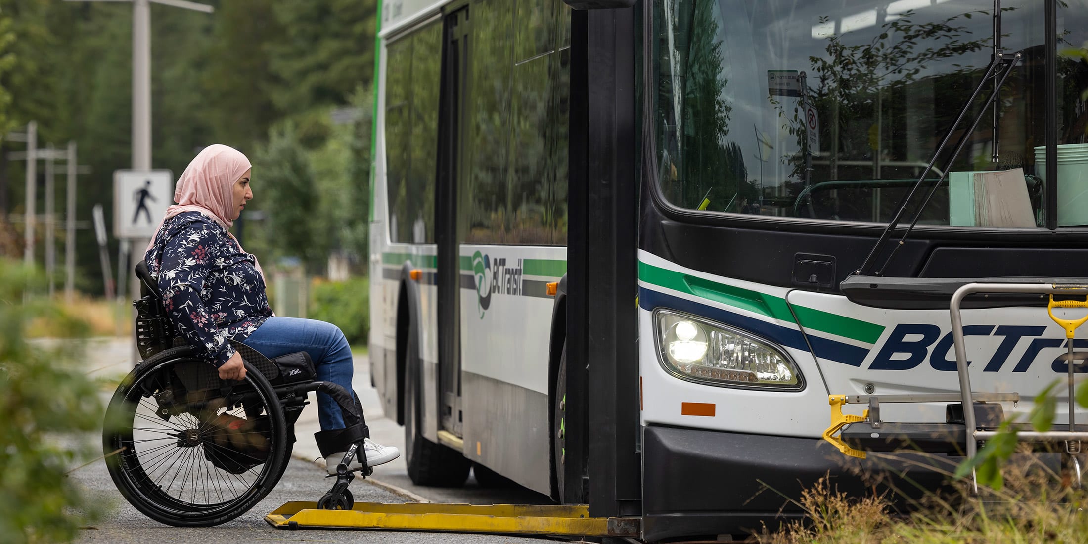 A person in a wheelchair boarding a local transit bus in Whistler