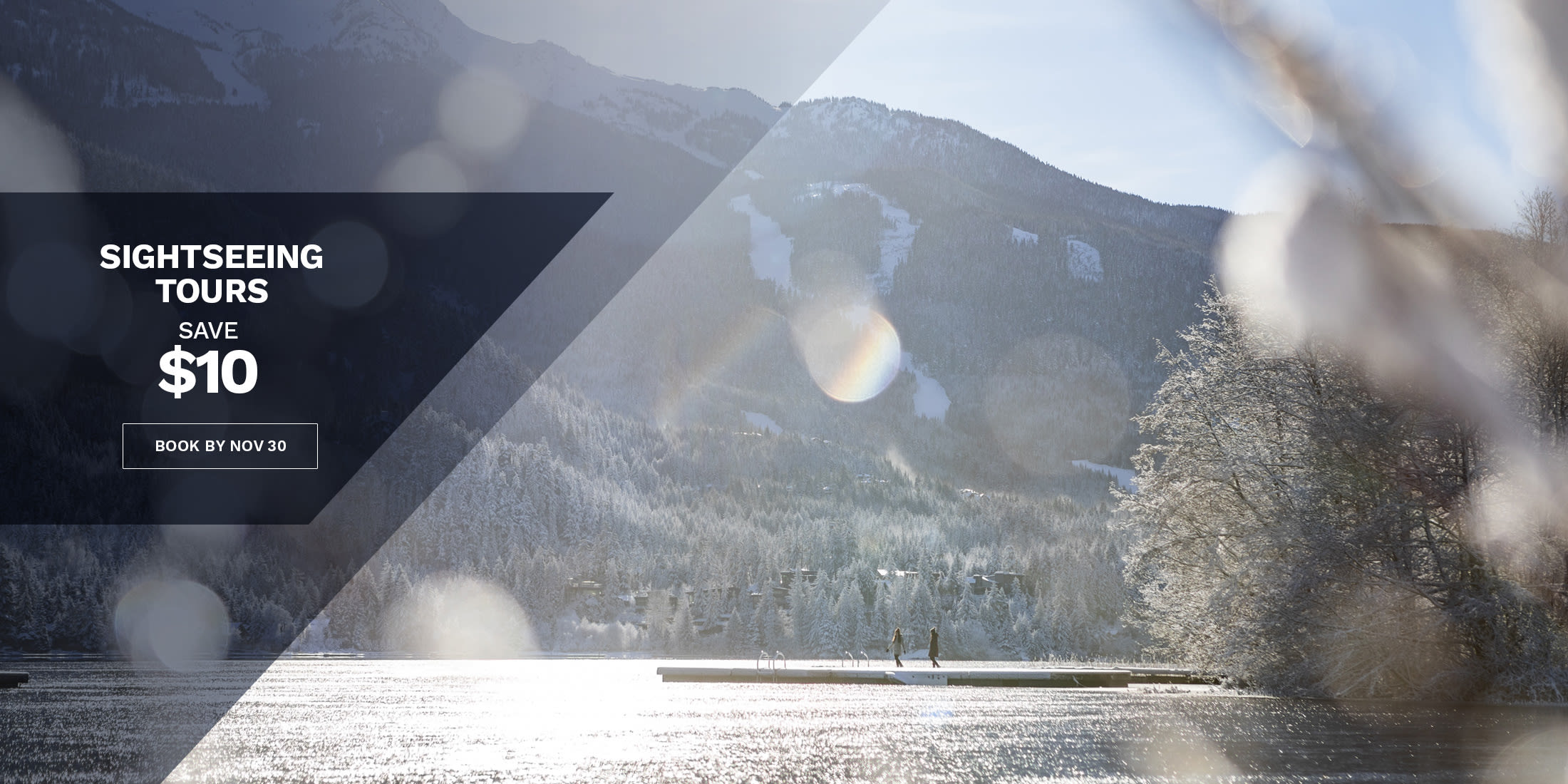Sightseeing Tours: save $10, book by Nov 30. Two people stand on a dock on a sunlit lake in Whistler, BC, with frosted forest and a snowy mountain with ski runs behind.
