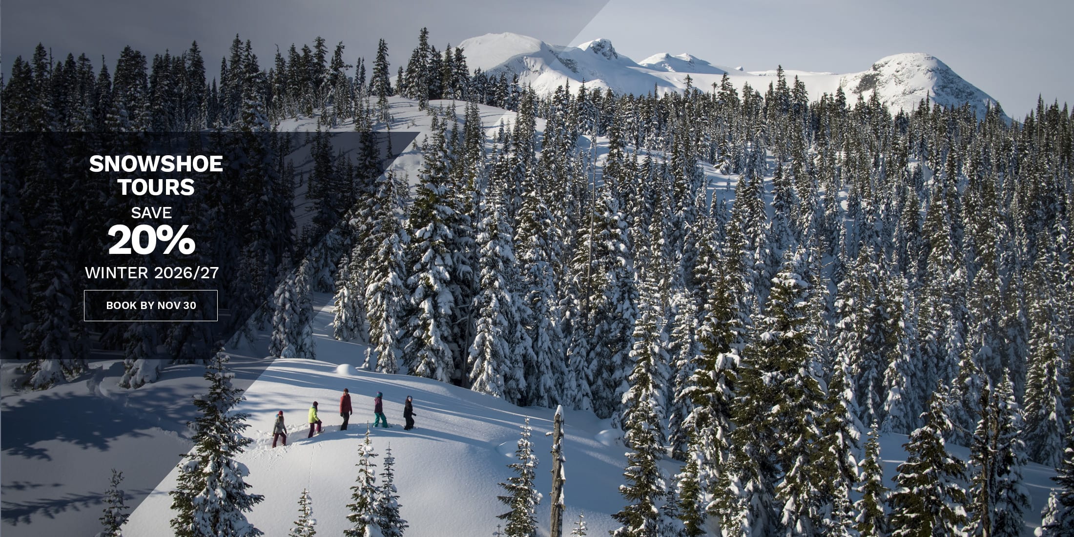 Snowshoers cross a snowy alpine ridge in Whistler surrounded by snow-covered peaks and evergreen forest. Save 20% on snowshoe tours for winter 2026/27 when you book by November 30.